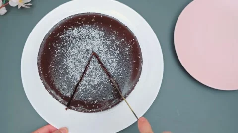 Cutting a glossy moist chocolate cake with a knife Stock-Footage 252195365