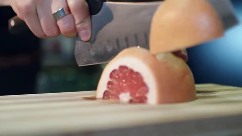 Cutting a grapefrui Stock Footage 129087453