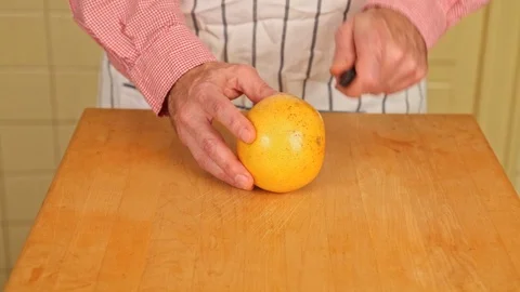 Cutting a Grapefruit in Half Stock Footage 126655276