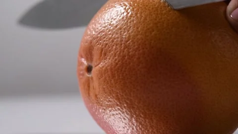 Cutting a grapefruit with a steel knife. Stock Footage 131978201