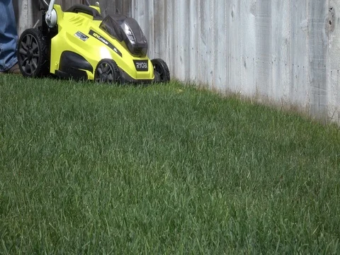 Cutting Grass with a battery powered lawn mower Video stock 78080213