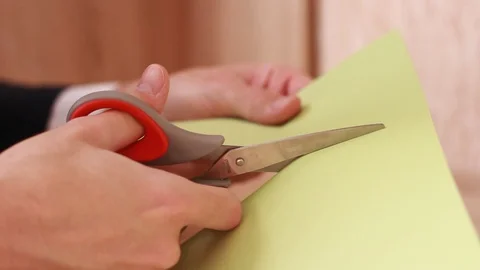 Cutting green blank sheet of paper with scissors 動画素材 86231982