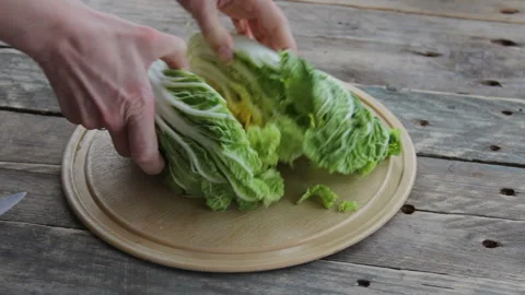 Cutting Green Chinese Cabbage With A Knife On The Wooden Desk Stock Footage 130530638
