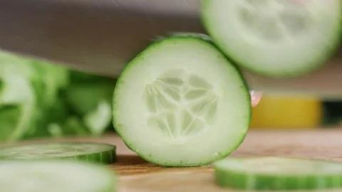 Cutting green fresh cucumber Stock Footage 72892386