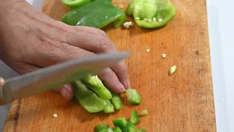 Cutting green pepper, on a table. In little pieces Stock Footage 219720389