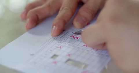 Cutting grid paper template for checking student answer sheets efficiently. Stock Footage 317756903