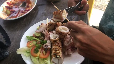 Cutting grilled fresh squid for lunch Stock Footage 270145950