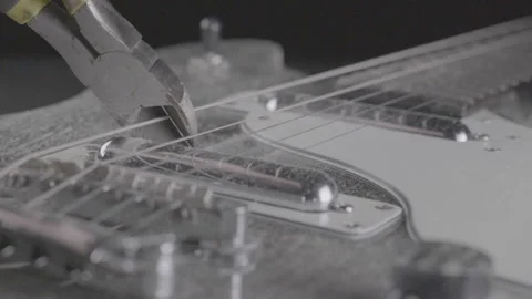 CUTTING A GUITAR STRING.  180FPS.  LOG, NO LUT APPLIED. Stockbeeldmateriaal 164169592