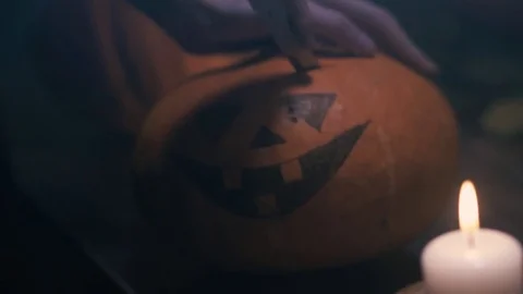 Cutting Halloween Pumpkin Top Part With Knife, Start making jack-lantern, with a Stock Footage 80243028