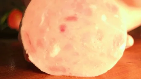Cutting a ham with a large knife. Close up shot. Stock Footage 82426549