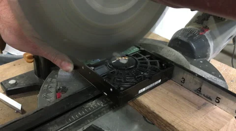 Cutting hard disk drive in half with chop saw Stock-Footage 58603570