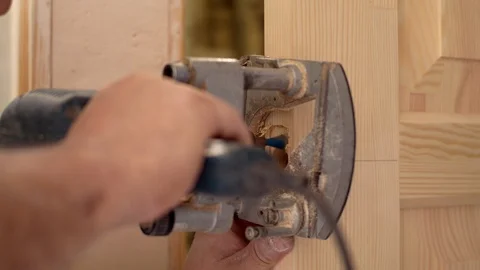 Cutting a hole for a lock Video stock 95001700