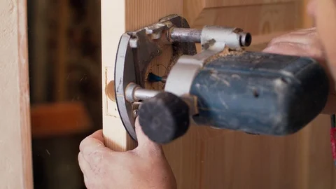 Cutting a hole for a lock Video stock 95002624