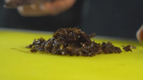 Cutting hookah tobacco on table Stock Footage 102524258