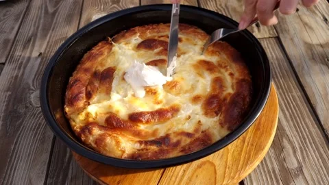 Cutting hot cheese with a knife Stock Footage 228993258