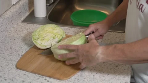 Cutting Iceberg Lettuce in Half   Stock Footage 340563621