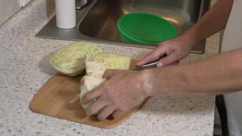 Cutting Iceberg Lettuce into Wedges   Stock Footage 340563622