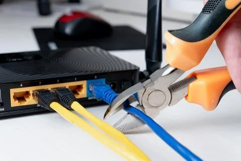 Cutting internet cable from router with wire cutters Stock Photos