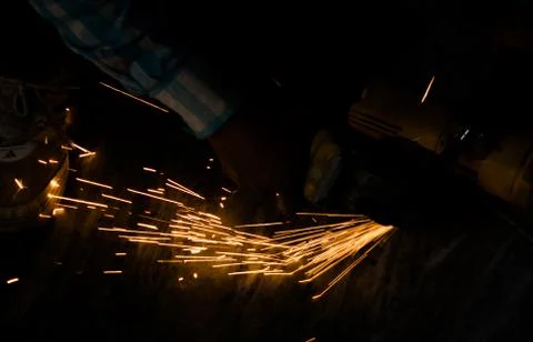 Cutting iron with angle grinder Stock Photos