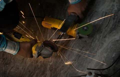 Cutting iron with angle grinder Stock Photos