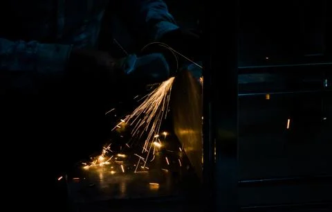 Cutting iron with angle grinder Stock Photos