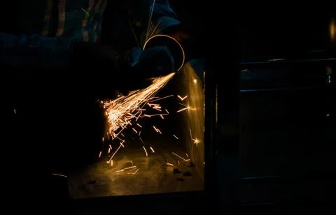 Cutting iron with angle grinder Stock Photos
