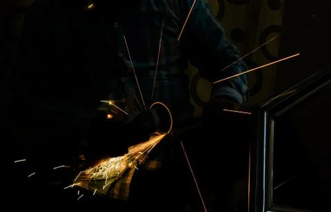 Cutting iron with angle grinder Stock Photos