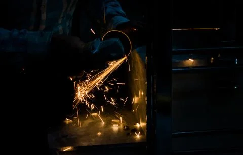Cutting iron with angle grinder Stock Photos