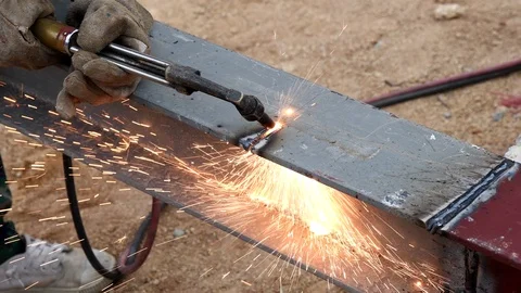 Cutting iron with gas torch at work in construction site Stock Footage 98976795
