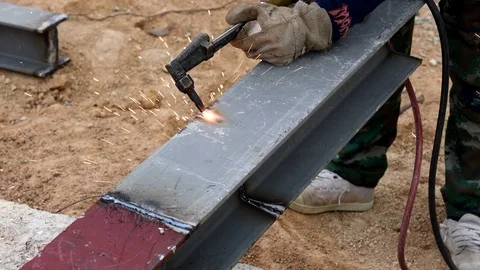 Cutting iron with gas torch at work in construction site Stock Footage 98976885