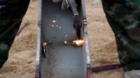 Cutting iron with gas torch at work in construction site Stock Footage 98976977