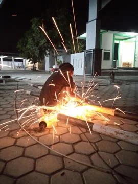 Cutting iron with a grinder Stock Photos