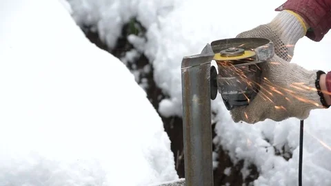 Cutting iron L-bar with angle grinder Stock Footage 70410813