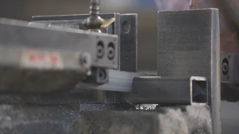 Cutting iron square profile with a saw with rising smoke 스톡 동영상 111569459