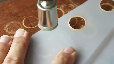 Cutting keyholes in plastic sheet Stock Footage 76170077