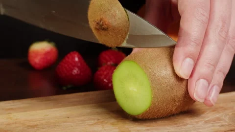 Cutting kiwi with grater close-up. Preparing some fruits for cooking. Health and Stock Footage 262609505