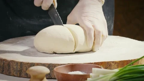 Cutting kneaded dough in half Stock Footage 138126413