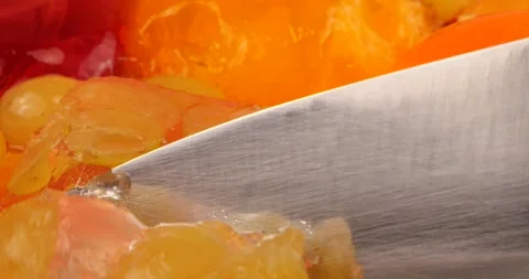 Cutting with a knife blade of a multi-colored berry gelatin jelly  Video stock 220125852
