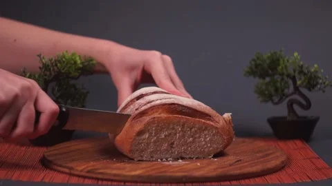 Cutting with a Knife Crusty Artisan Bread in the Kitchen 스톡 동영상 217408104