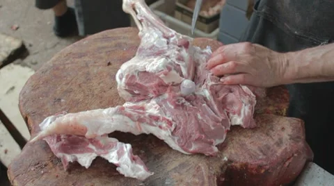 Cutting with knife tendon connecting the tibia on mutton leg Stock-Footage 8366890