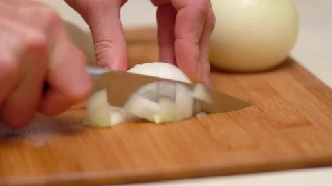 Cutting large onion. Female hands cut onions with knife. Close-up. Stock Footage 144432017
