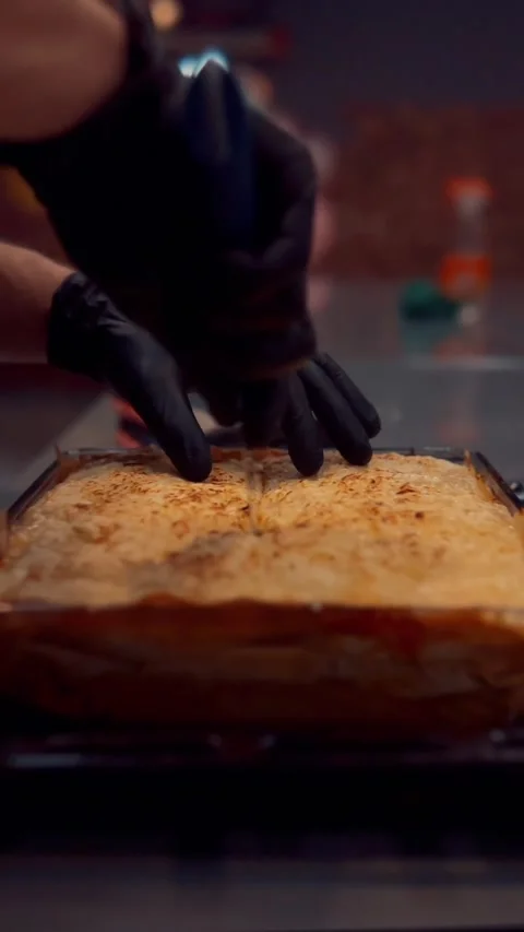 Cutting Lasagna in Gloves Stock Footage 180436930