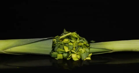 Cutting leek onion on black background Stock-Footage 99154267