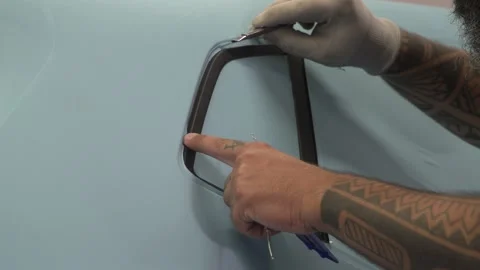 Cutting of the leftover film applied on the side window Stock Footage 207683633