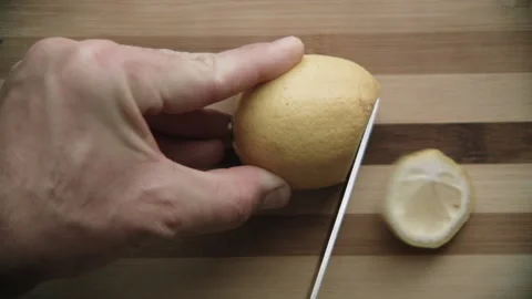 Cutting lemon on a cutting board Stock Footage 132217929