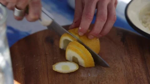 Cutting lemon with a kitchen knife Stock Footage 133749486