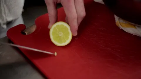Cutting a lemon removing its seeds and squeezing it Stock Footage 307340034