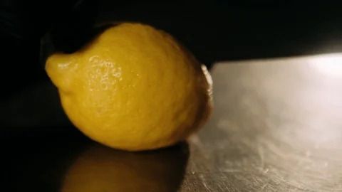 Cutting a lemon in two parts Stock Footage 125458670
