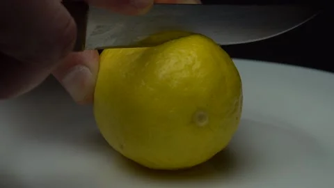 Cutting lemon on the white plate Stock Footage 85745783