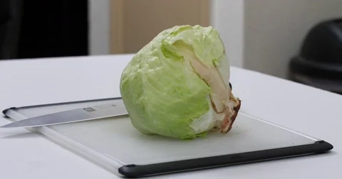 Cutting up lettuce on a cutting board Stock Footage